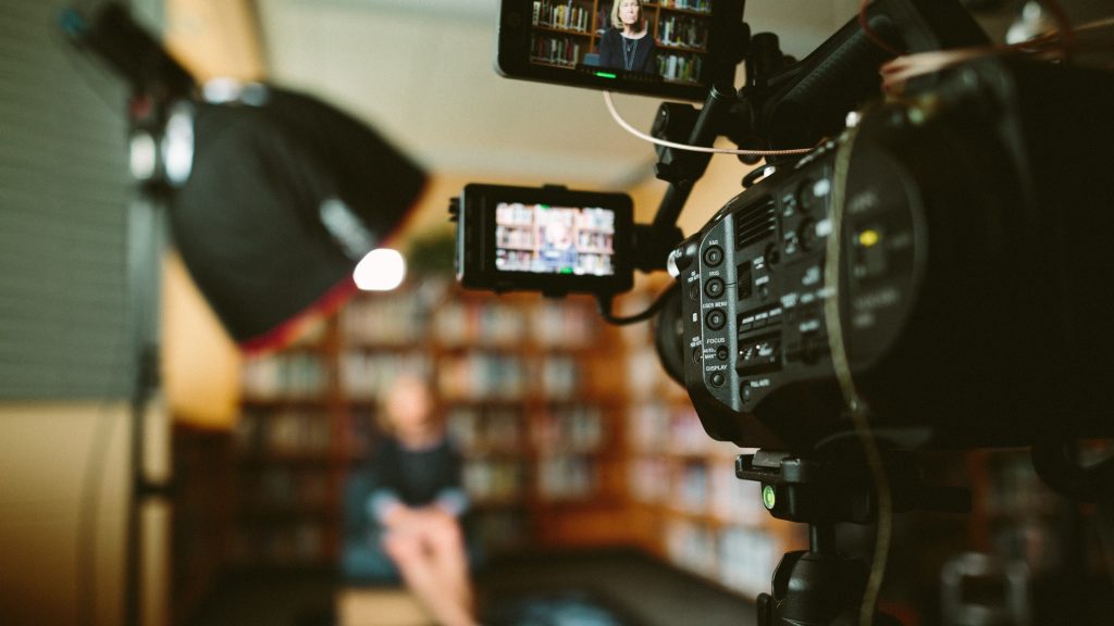 woman in front of camera in library