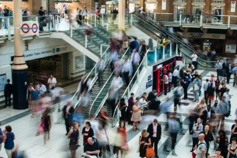 aerial shot of people walking around a crowded indoor mall