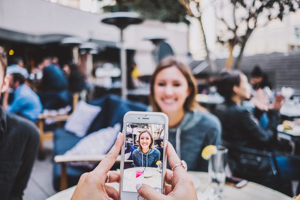 girl smiling for a photo on a restaurant patio