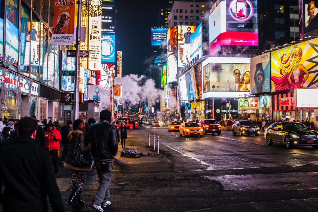 urban city street with ads and pedestrians