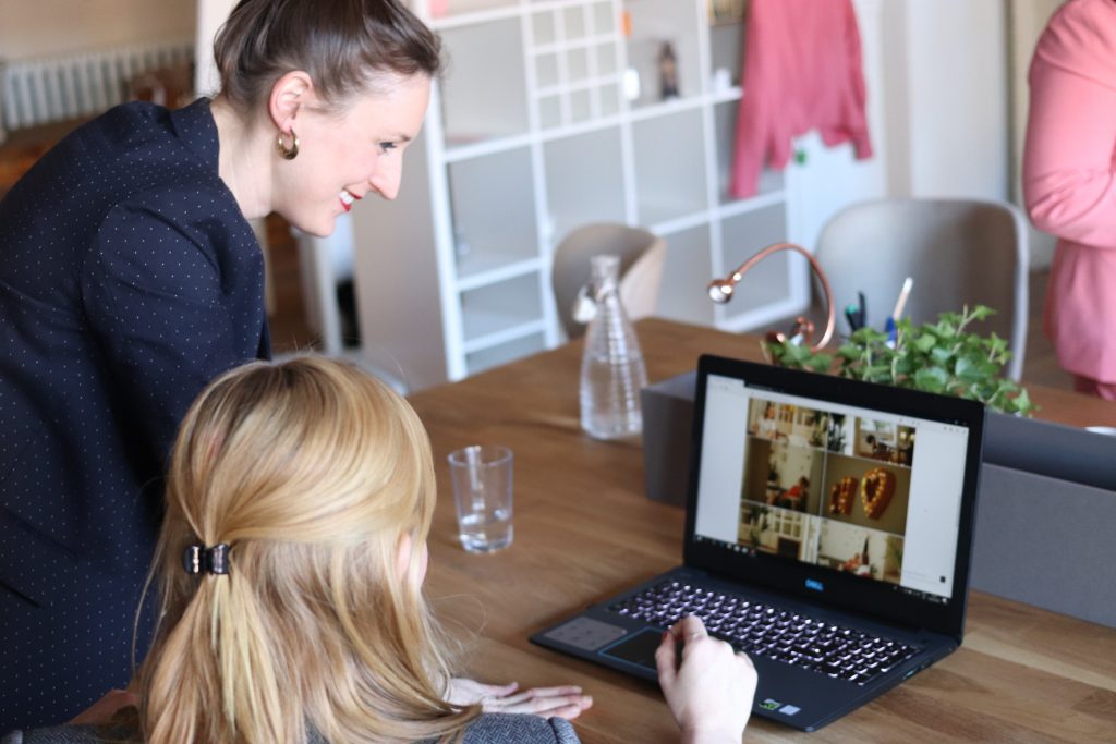 two woman looking at e-commerce site on laptop