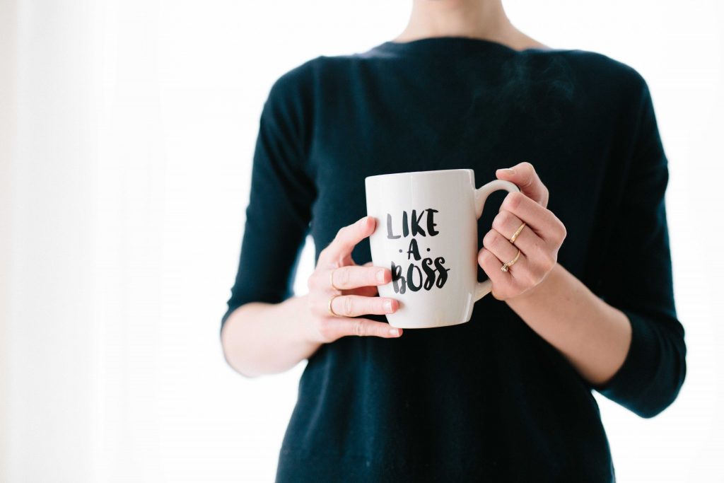 woman holding "like a boss" mug