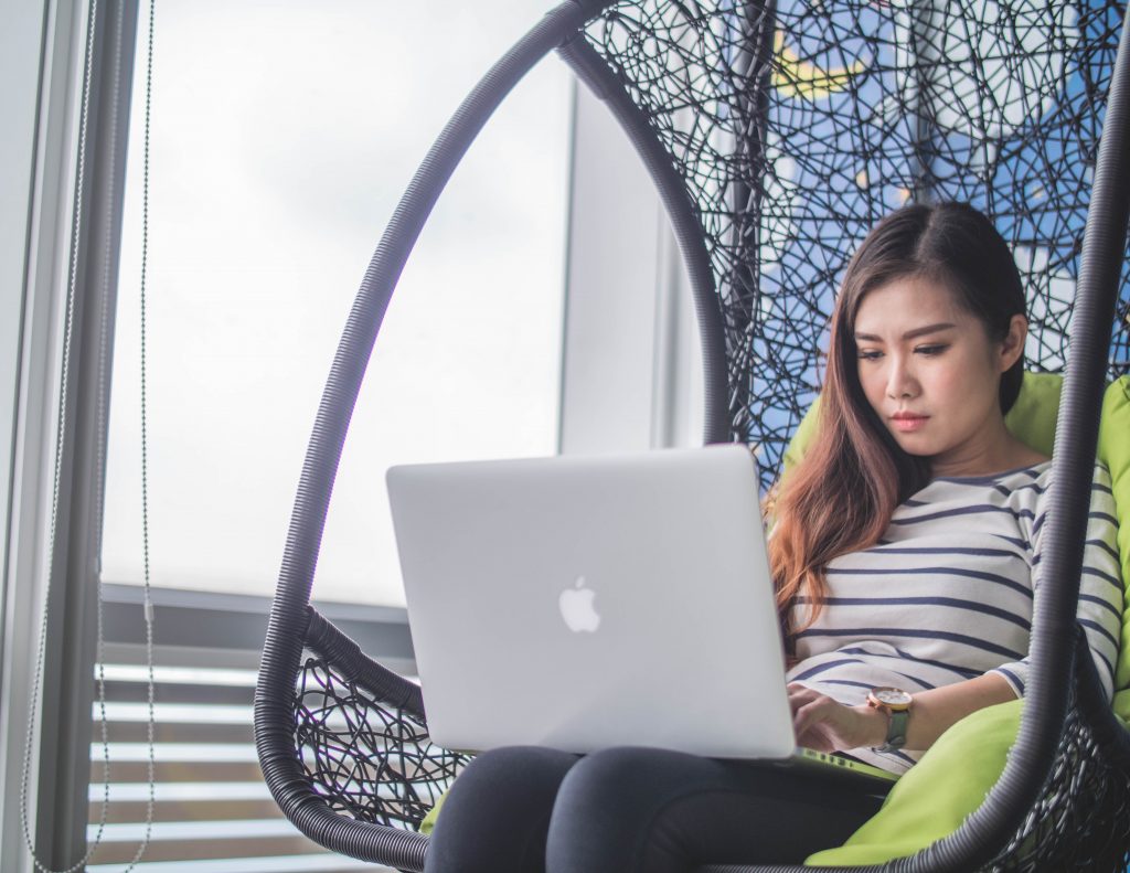 girl in chair on computer