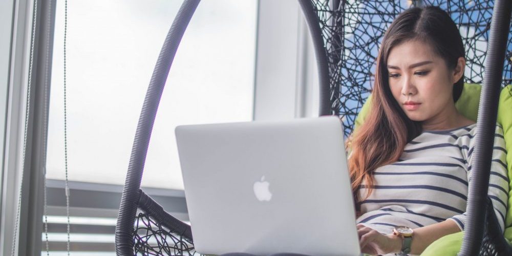 girl in chair on computer