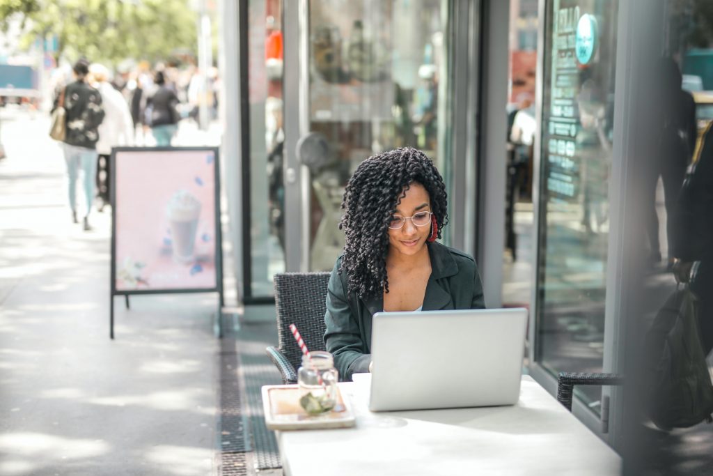 woman sitting outside with a laptop