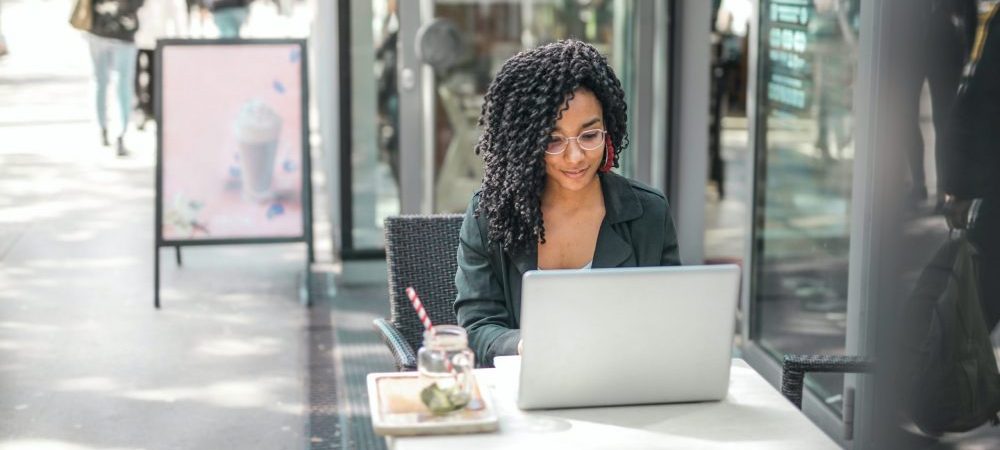 woman sitting outside with a laptop