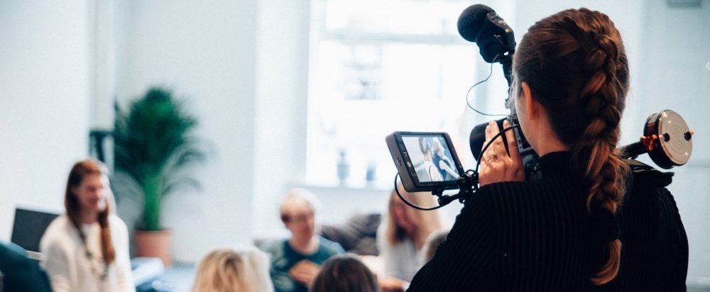 women videotaping a group of women