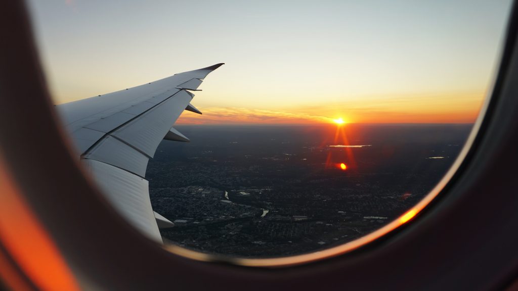 view of a plan wing from the plane window in the sky