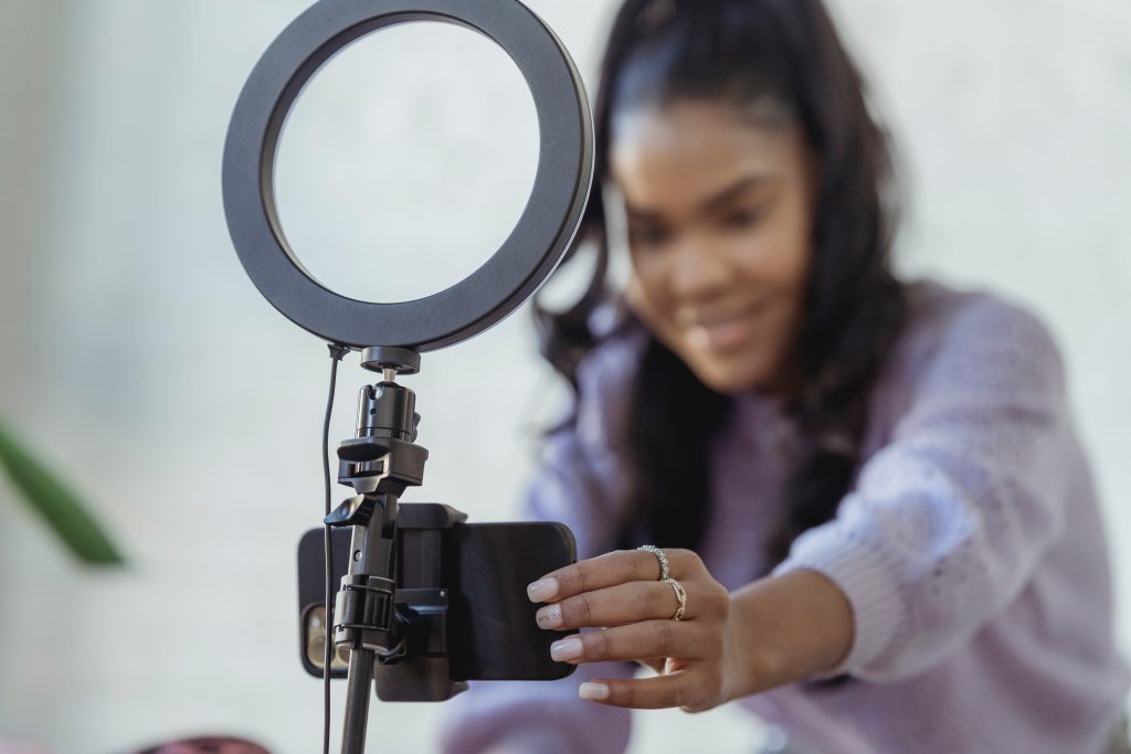 young woman setting up smartphone to record a video