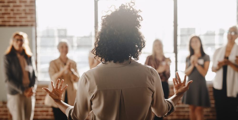 African american female empowering other colleagues in workplace