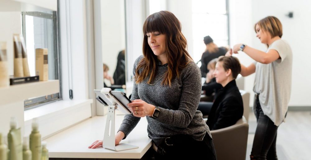 woman using an ipad at a hair salon