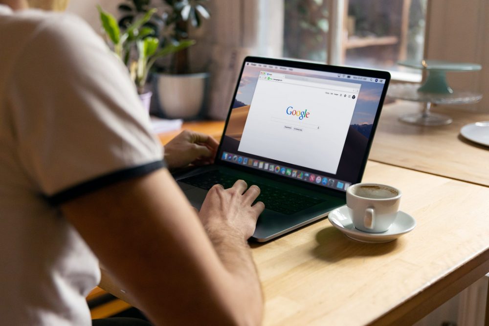 view from the back of a person using google on a laptop