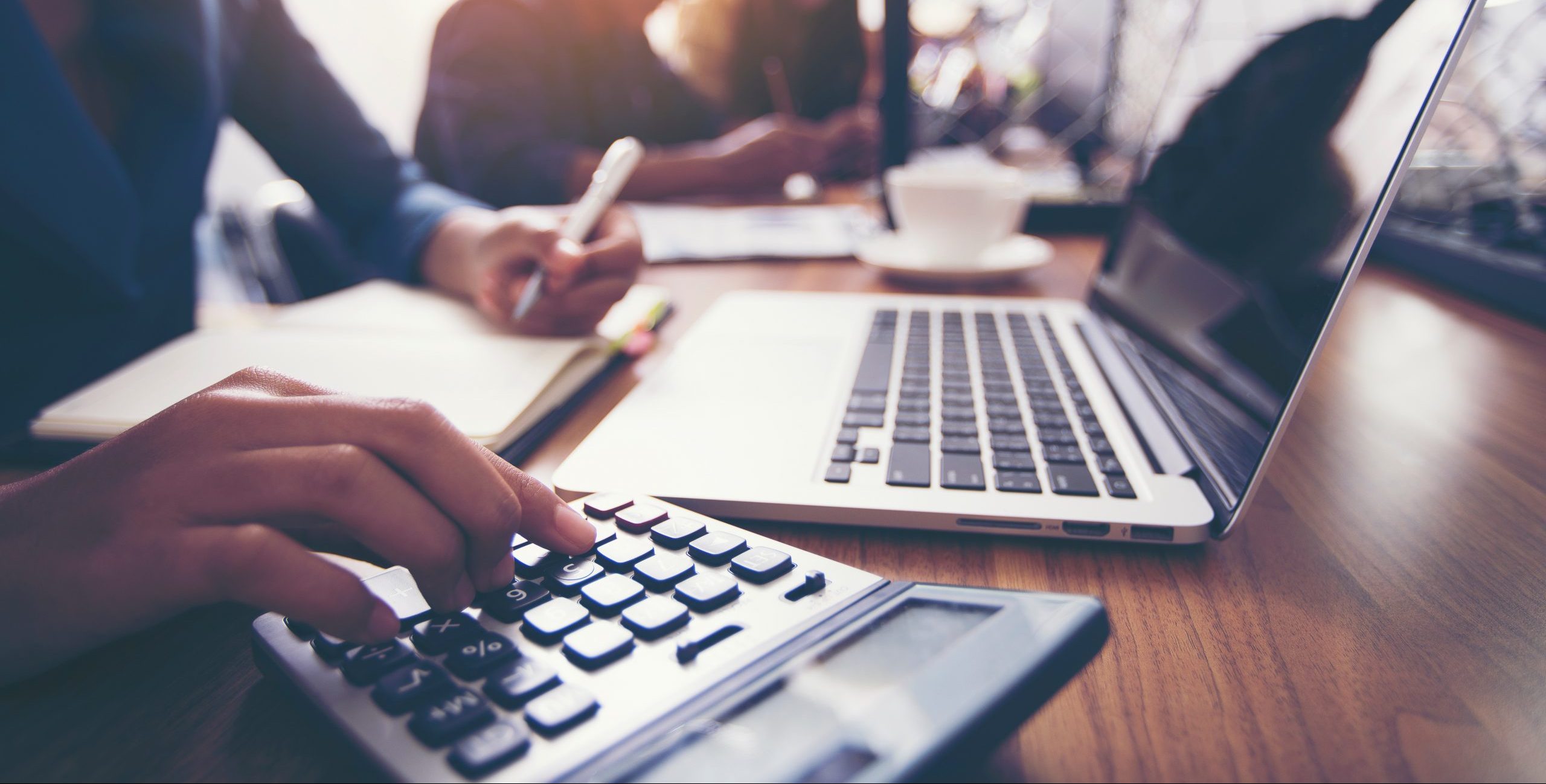 The hands of a female accountant using a calculator