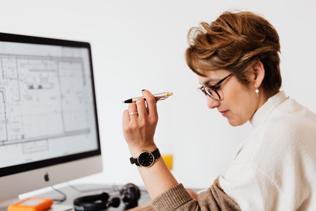 Woman at computer creating report